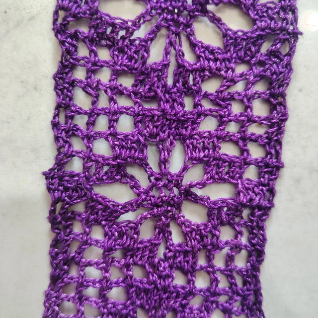 Purple crochet lace, close up.